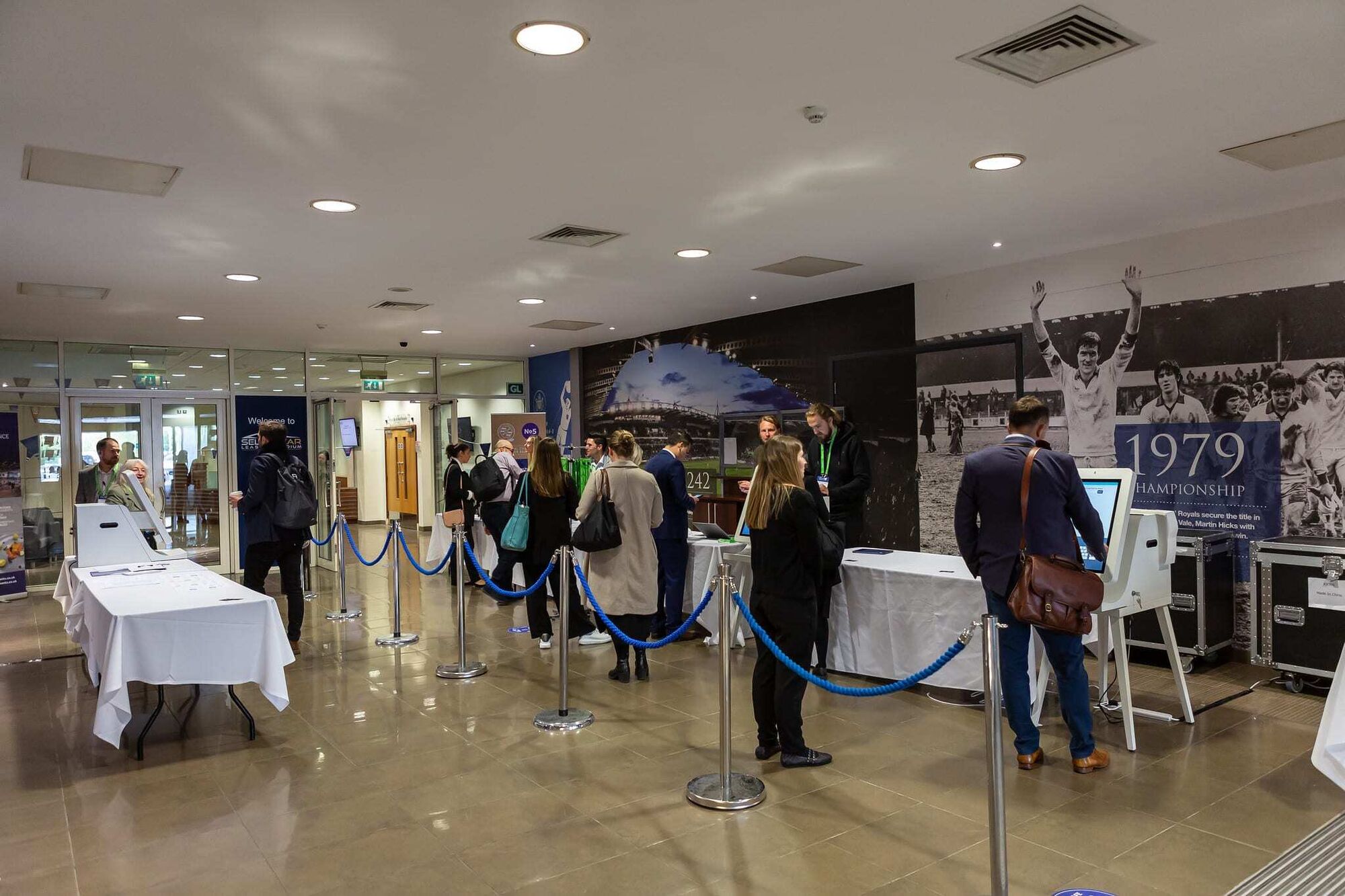 Registration and badging kiosks in the arrivals area at an ELN summit