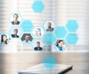 Headshots of business people arranged in a honeycomb of hexagonal tiles rising from a phone on a desk