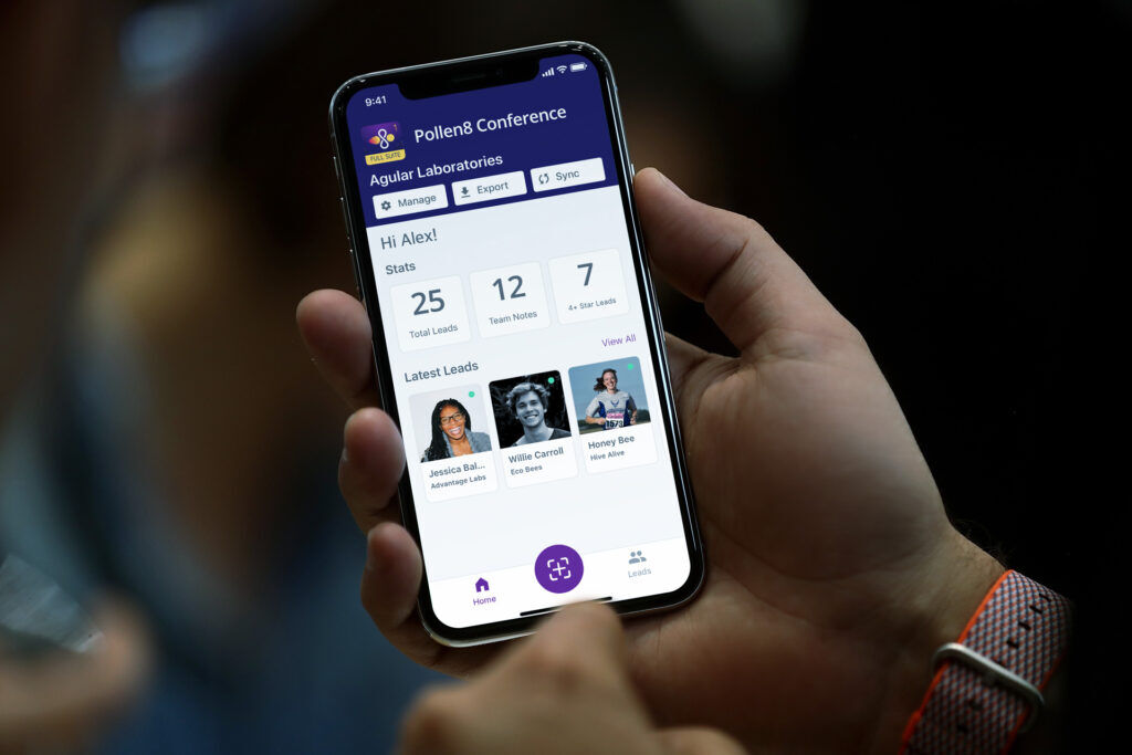 Hand holding a phone showing a Pollen8 Conference lead capture screen with 25 total leads, 12 team notes and recent lead cards