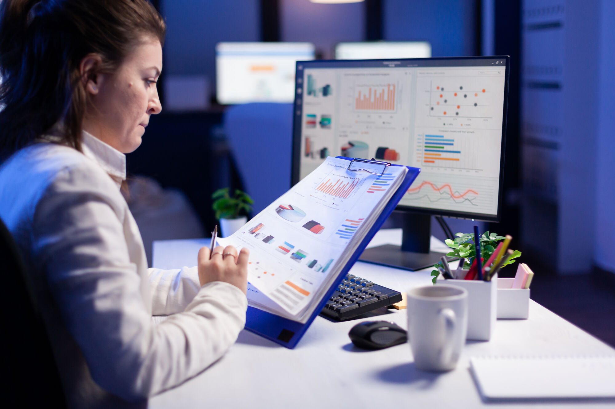 A content creator or marketer working on a structured document, with headings and bullet points visible on screen.