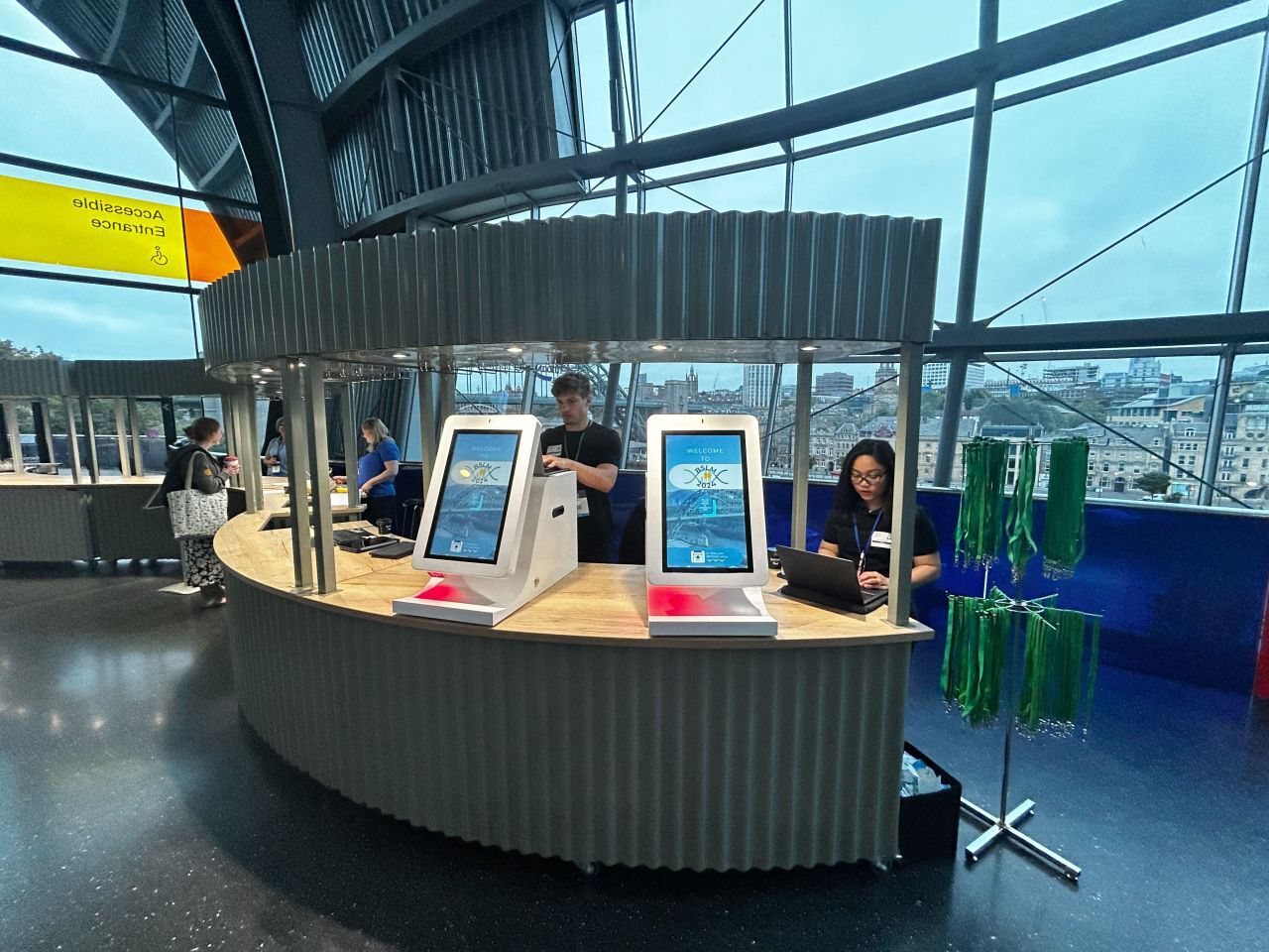 Attendees checking in on Glide kiosks at BSLM 2024 at the Glasshouse Gateshead