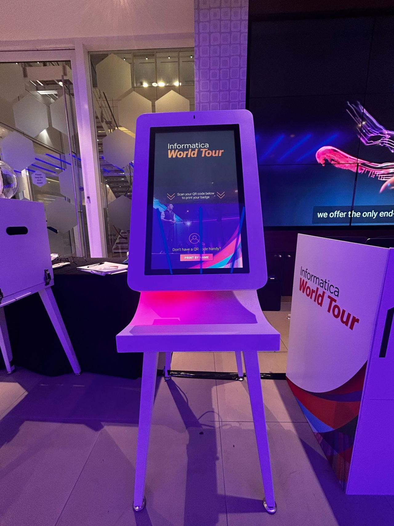 A Glide kiosk under purple lighting at an Informatica World Tour reception