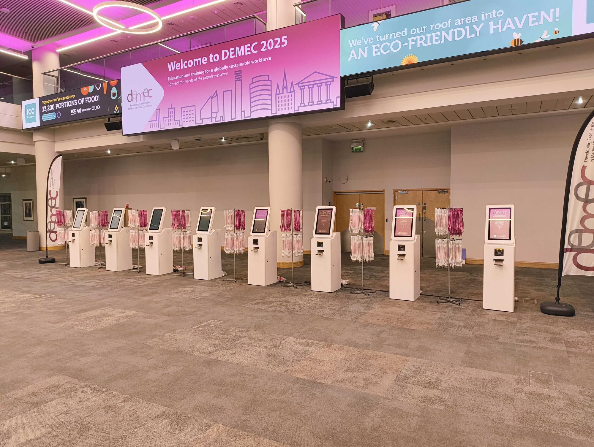 Max kiosks with lanyard stands ready for arrivals at DEMEC 2025