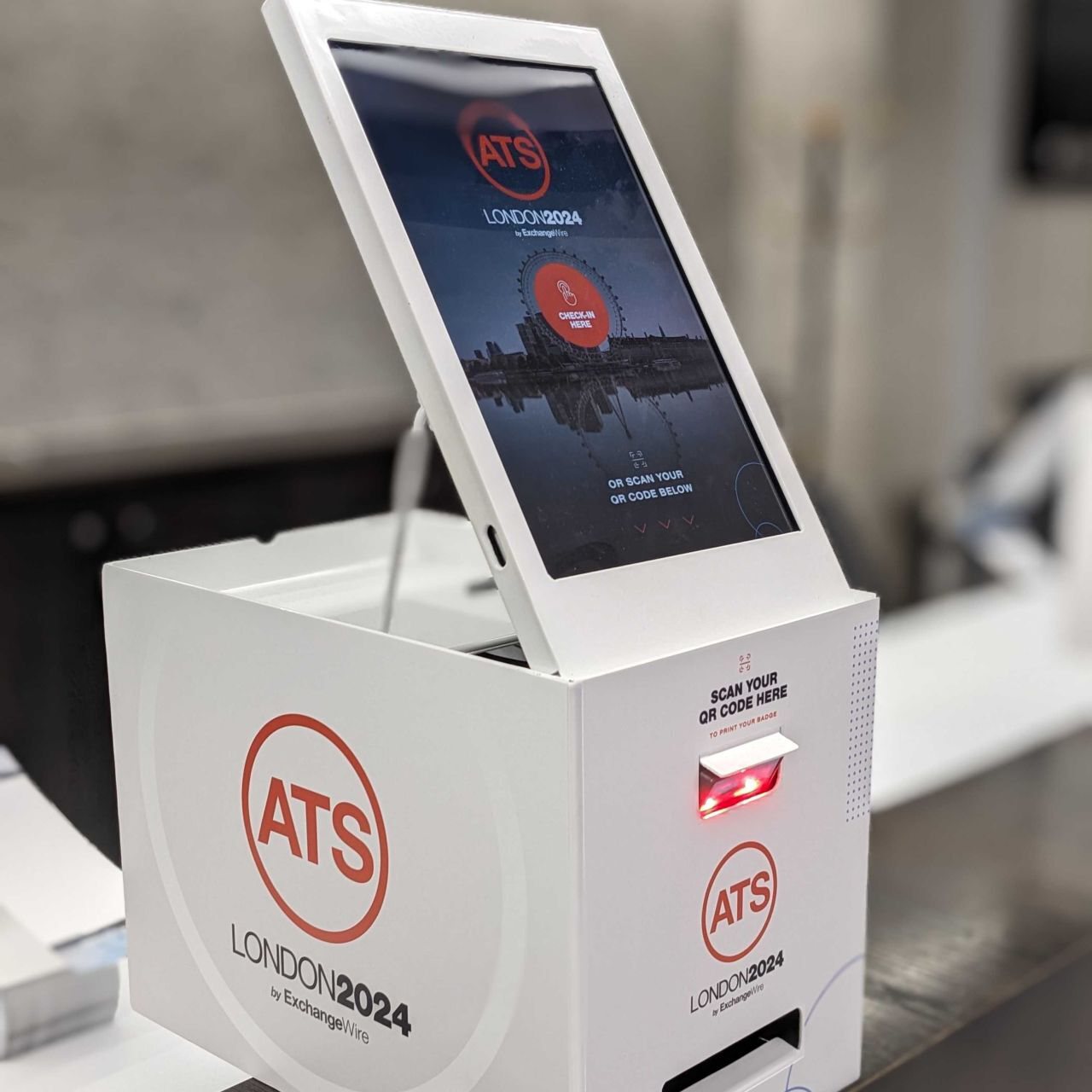 Close-up of a Mini kiosk with its QR scanner glowing at ATS London