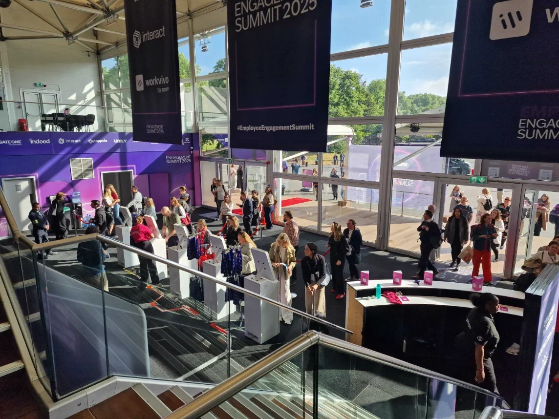 Attendees collecting badges at self-service kiosks