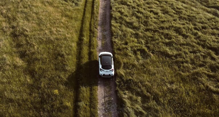 Electric car driving through fields