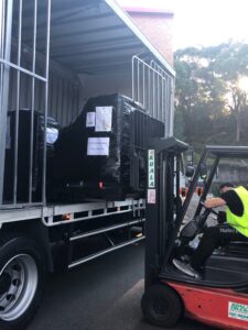 Kiosks being loaded onto a truck