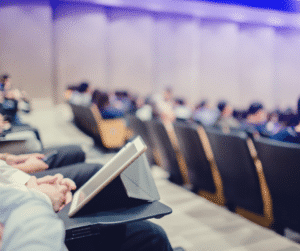 Shareholders taking notes at an AGM